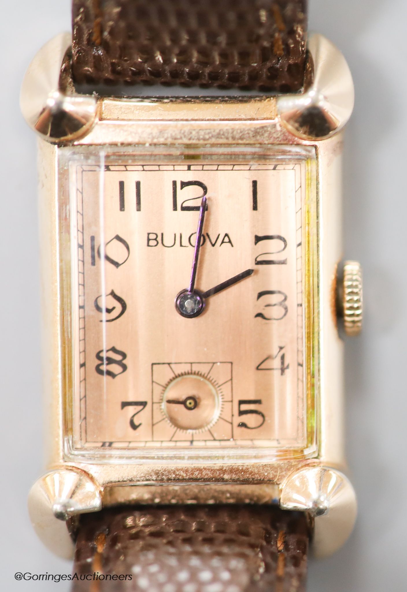 A gentleman's 1930's 14k gold filled Bulova manual wind rectangular dial wrist watch, with subsidiary seconds, on later leather strap.